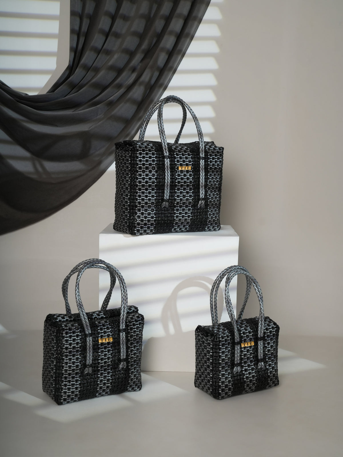 Three Closeweave Wire Basket (Black & Silver) with a geometric pattern on a white surface.