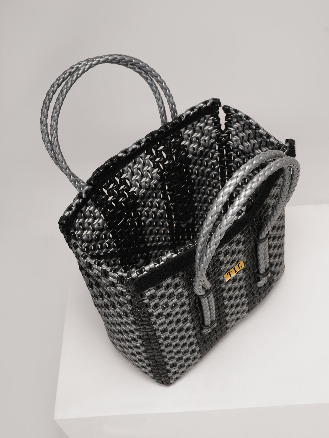 Closeweave Wire Basket  on a white pedestal with a light gray background