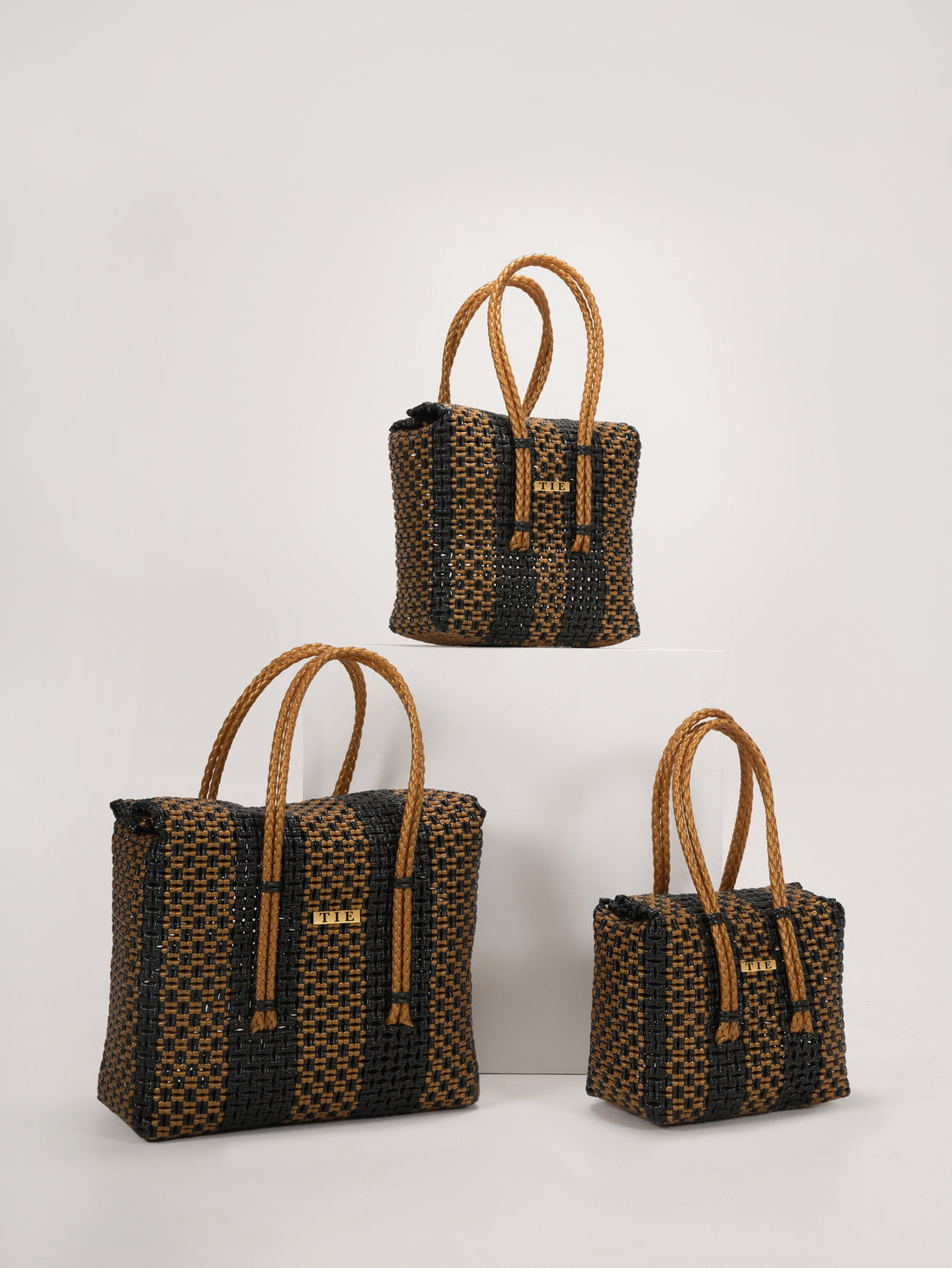 Three Closeweave Wire Basket (Black & Gold) with brown handles on a white background